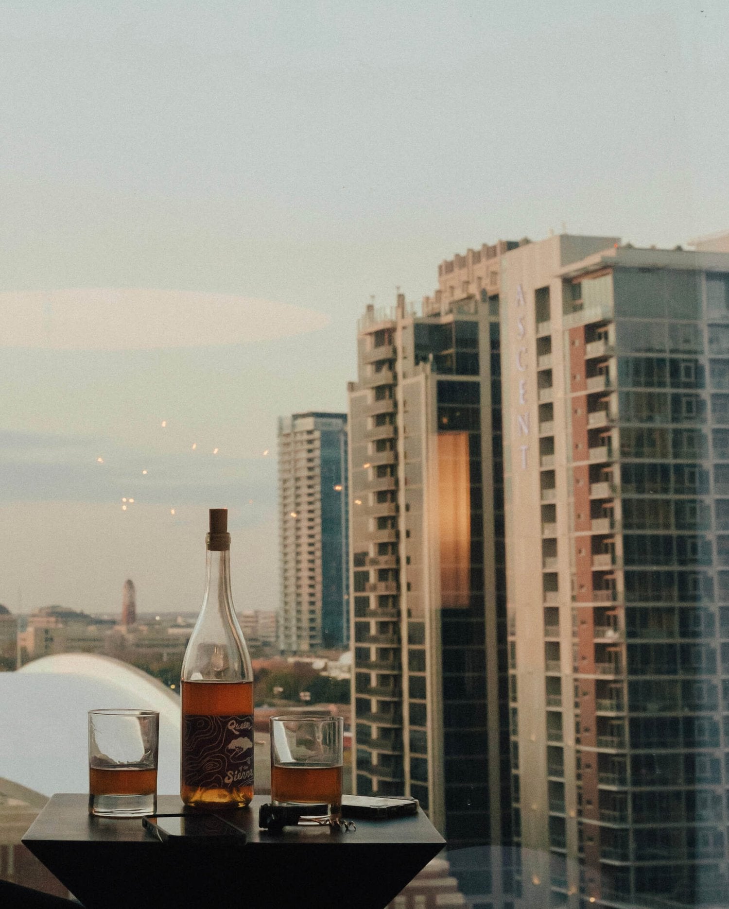 Social media content created for W Dallas showing wine bottle and wine glasses overlooking the Dallas skyline.