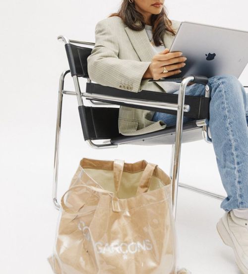 Woman working on a laptop sitting in Wassily Chair.