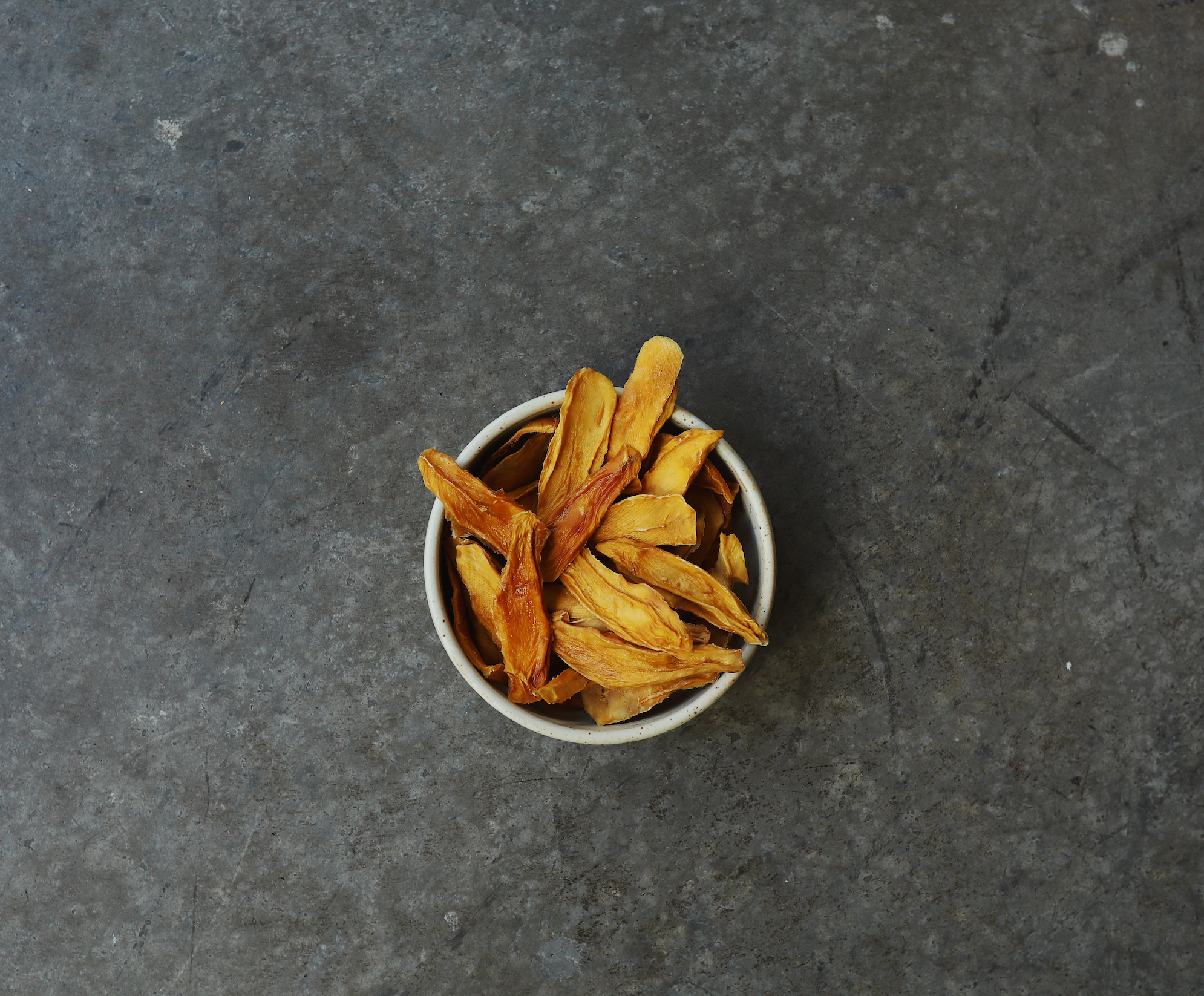 Visual work for Off The Tree Snacks showing a bowl of organic dried mangoes.