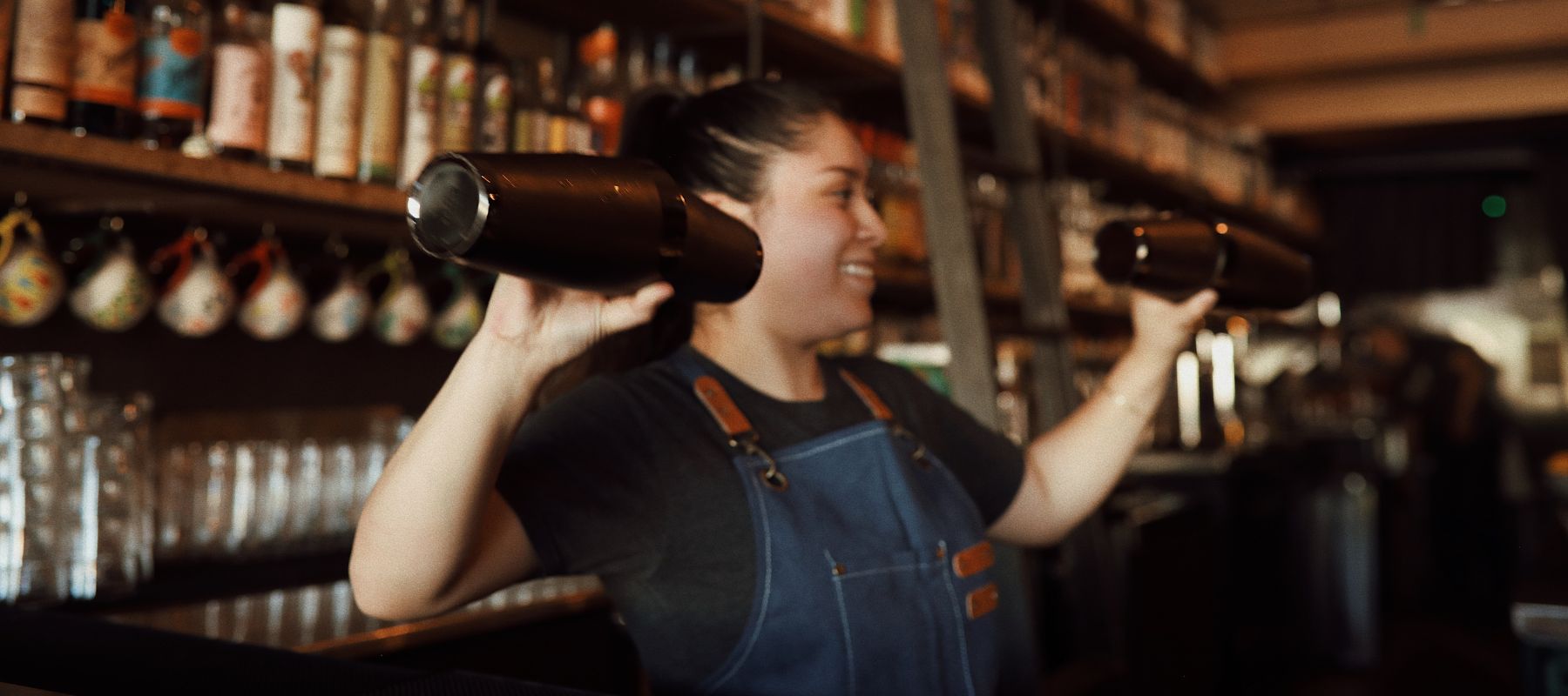 Photo shoot for Las Almas Rotas social media of bar tender shaking drinks.